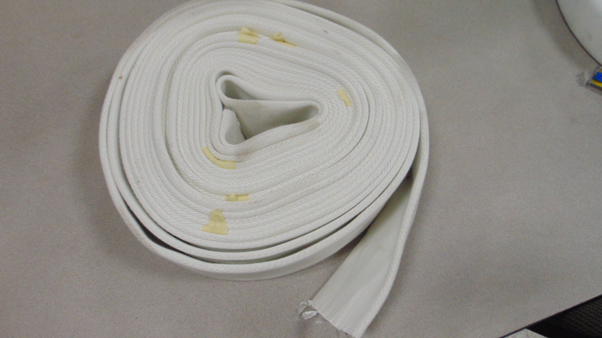 A white fire hose with no couplings