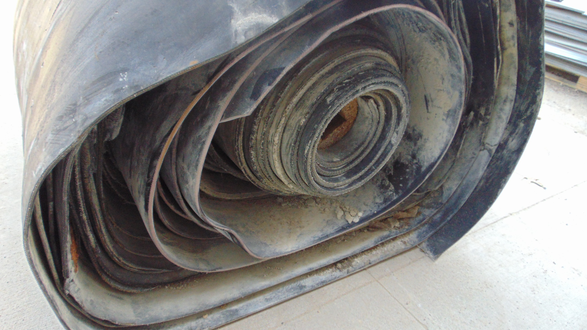 A roll of used rubber conveyor