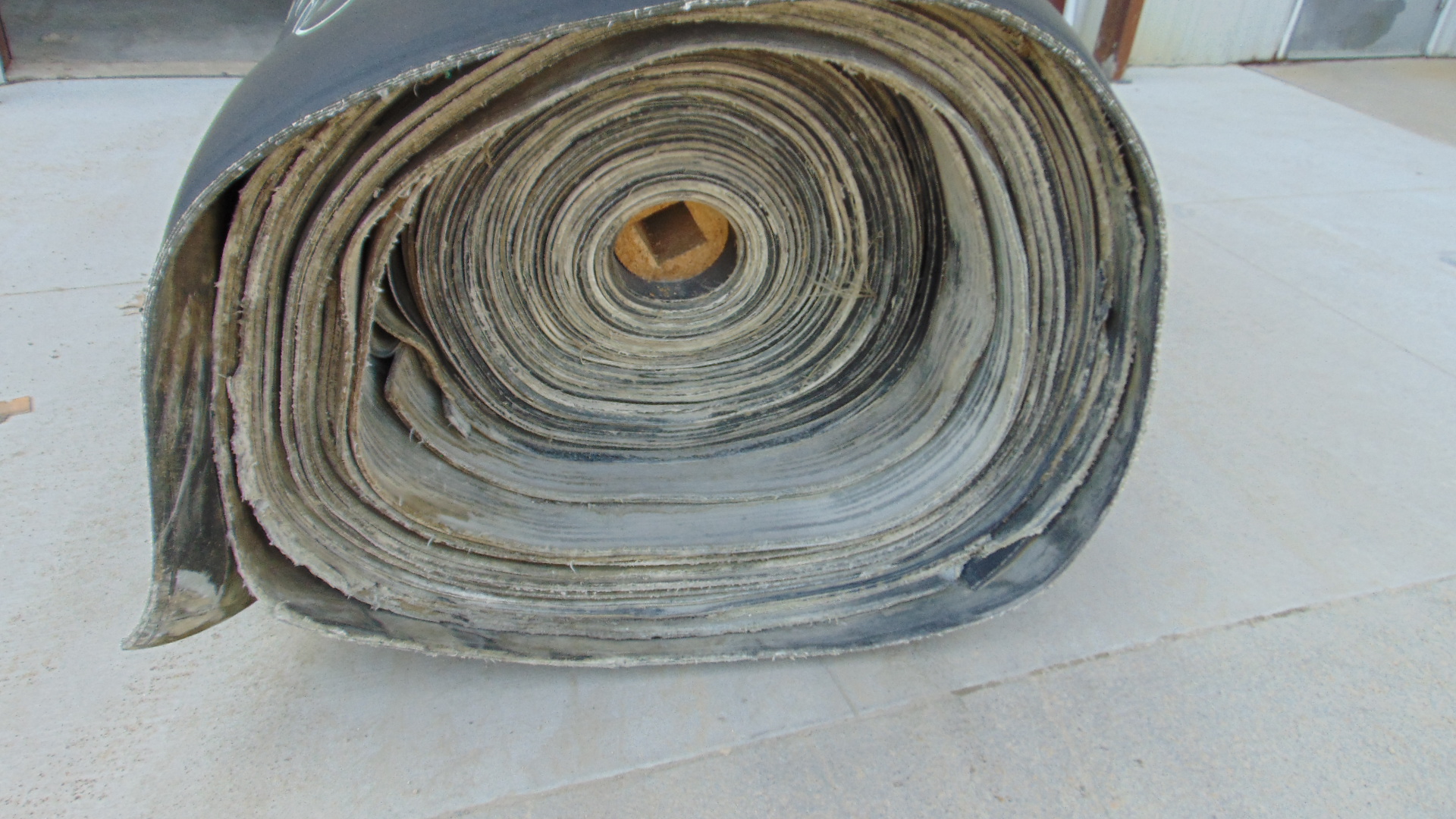 A roll of used rubber conveyor