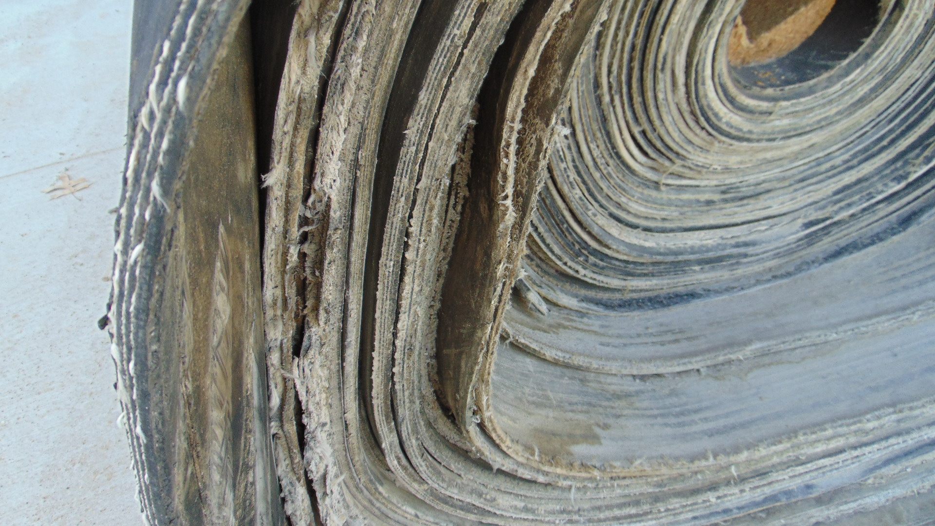 A roll of used rubber conveyor