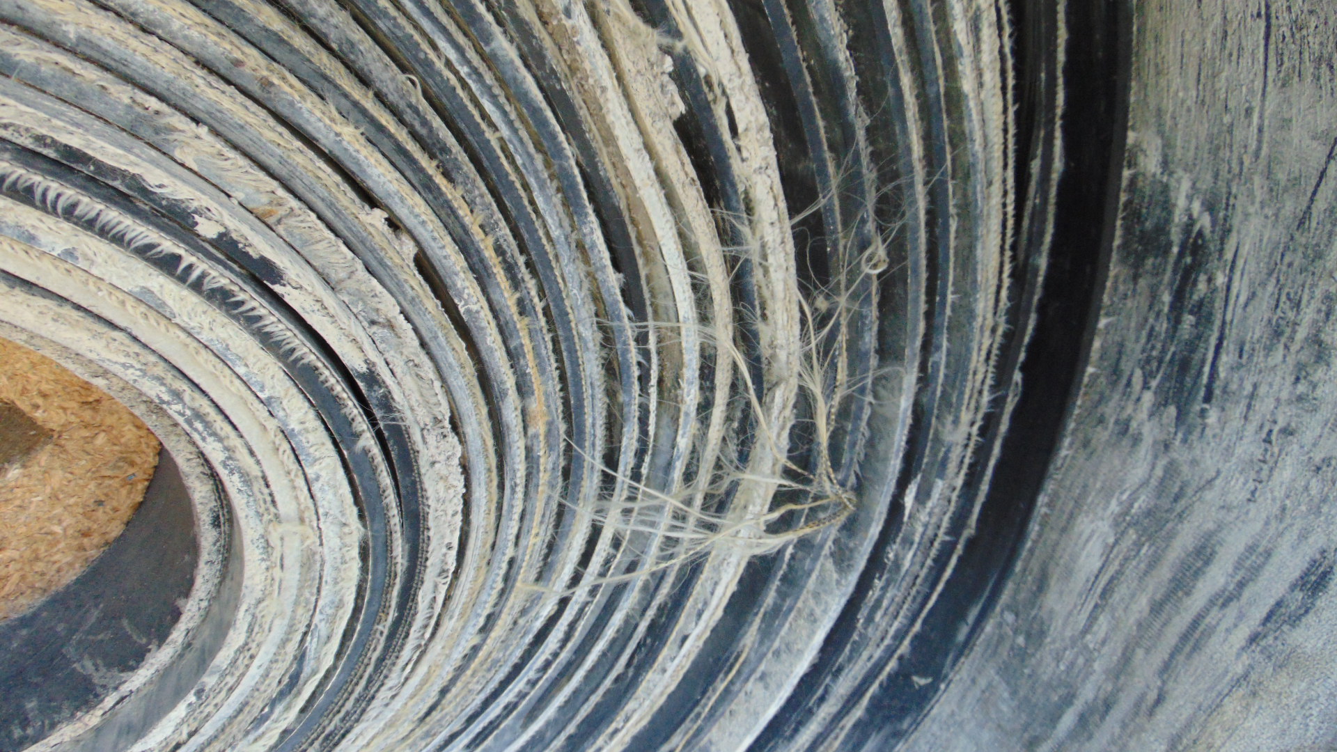A roll of used rubber conveyor