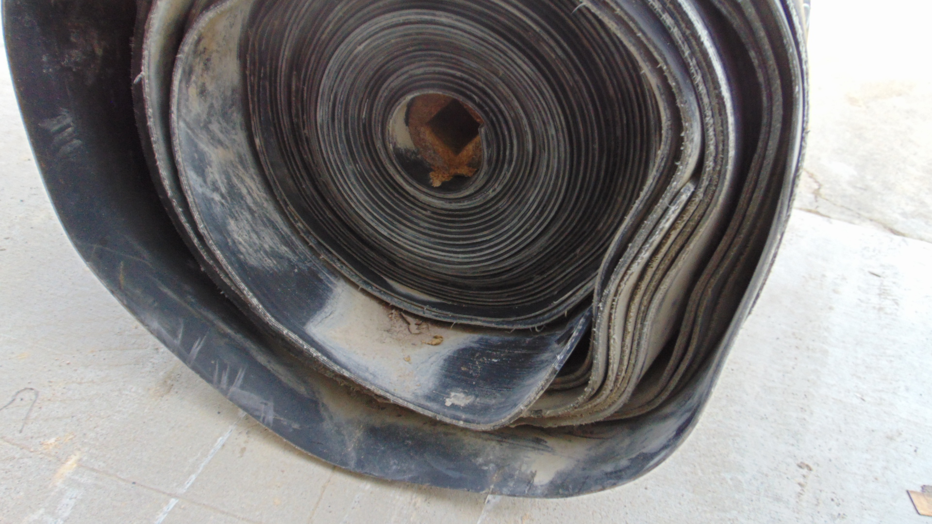 A roll of used rubber conveyor