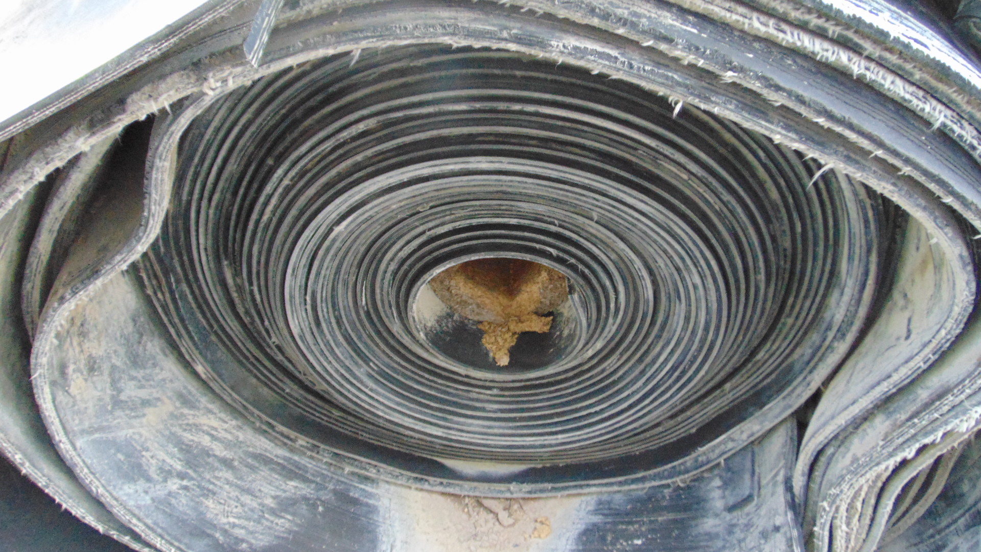 A roll of used rubber conveyor