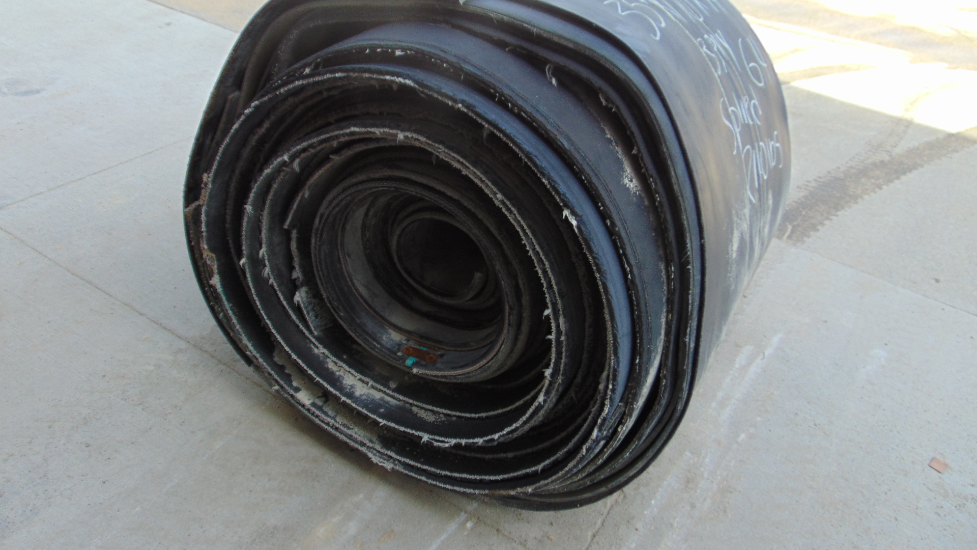 A roll of used rubber conveyor