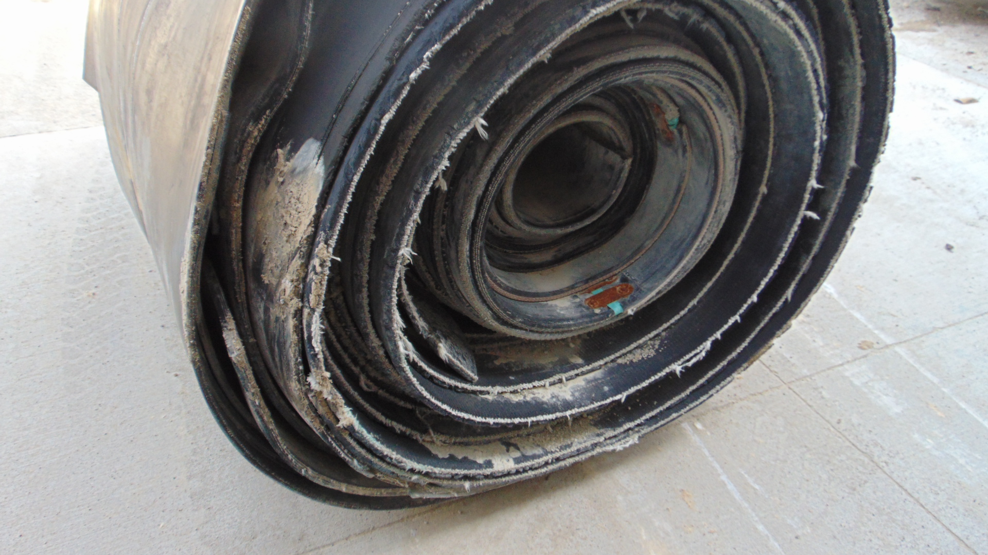 A roll of used rubber conveyor