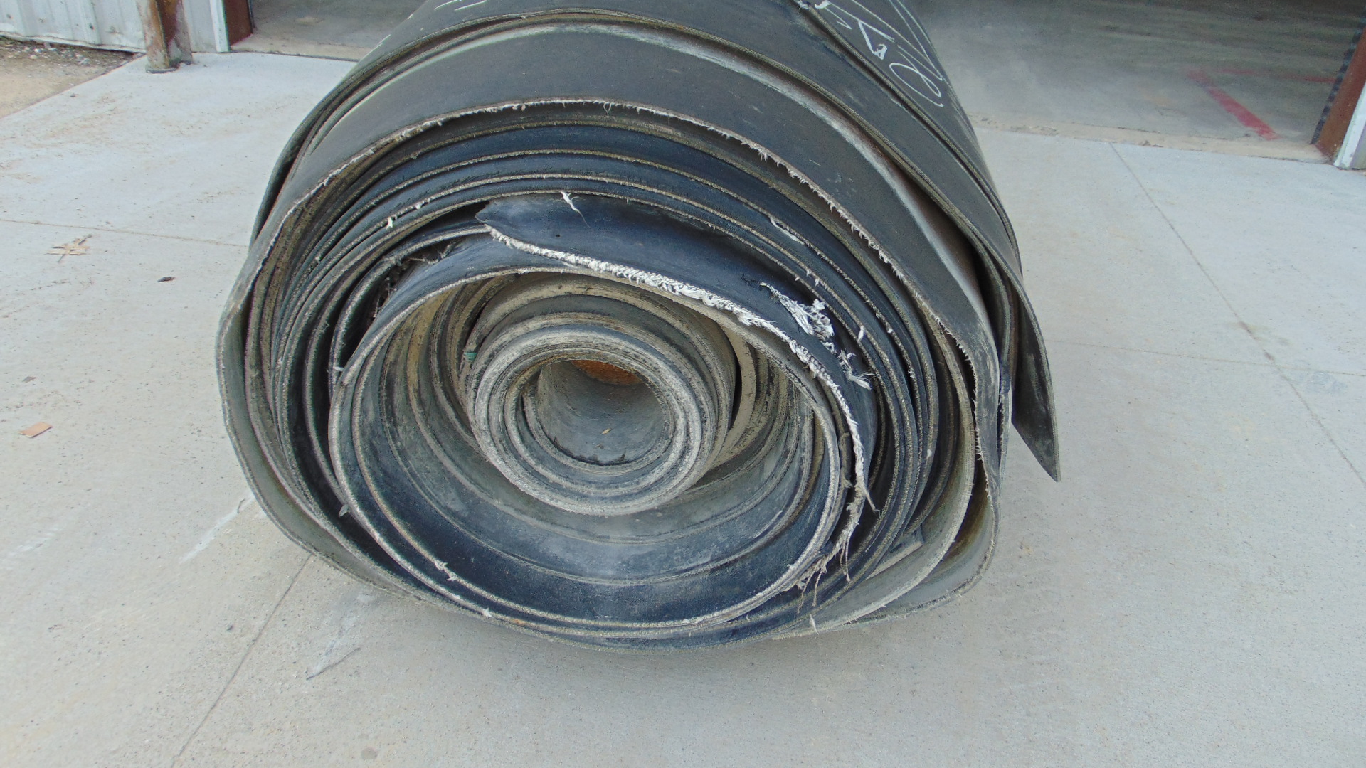 A roll of used rubber conveyor