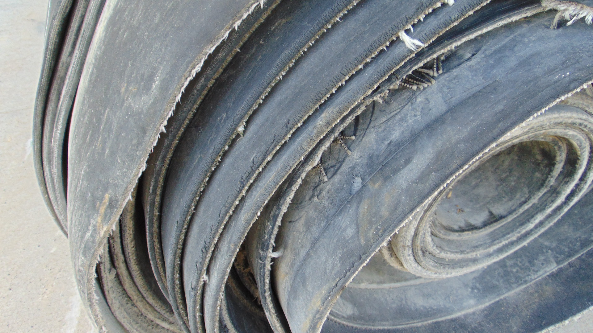 A roll of used rubber conveyor