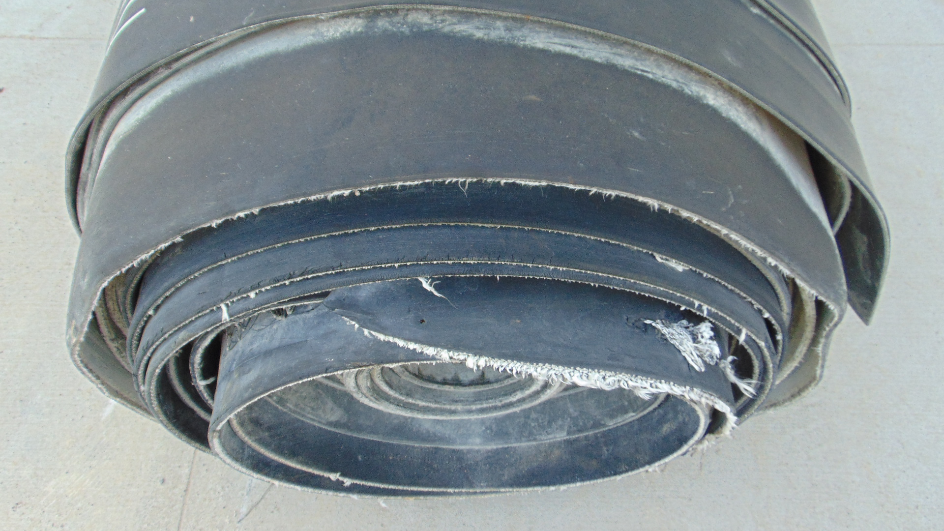 A roll of used rubber conveyor