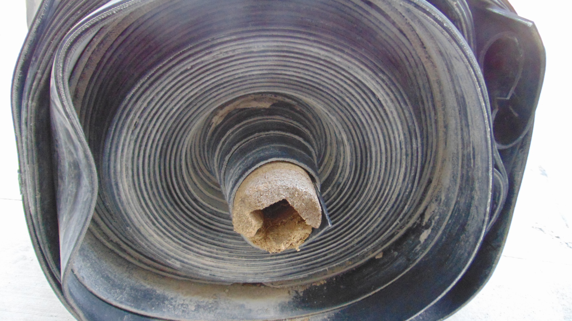 A roll of used rubber conveyor