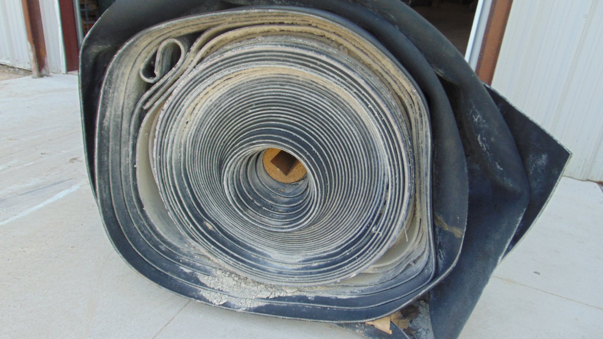 A roll of used rubber conveyor