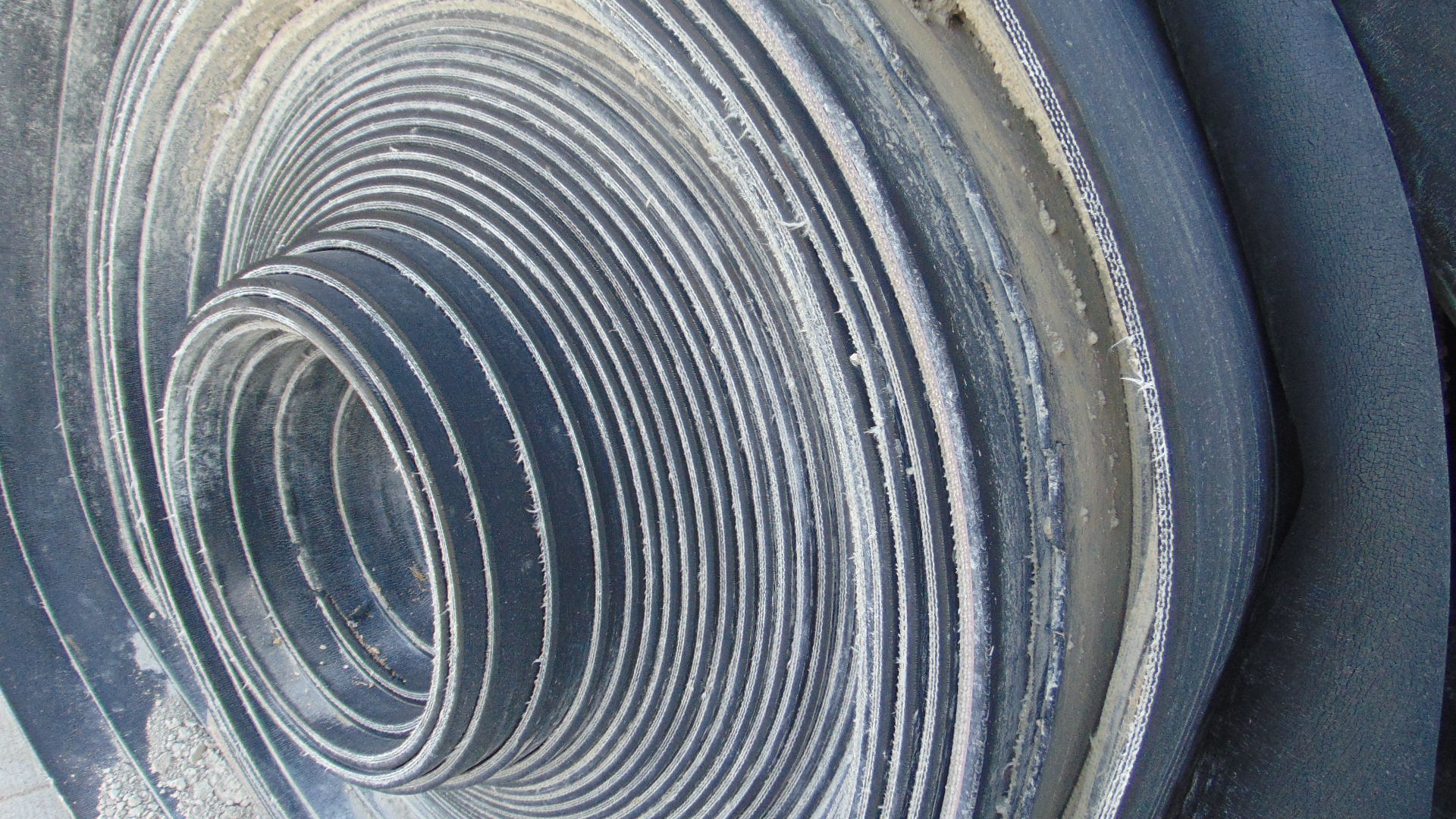 A roll of used rubber conveyor