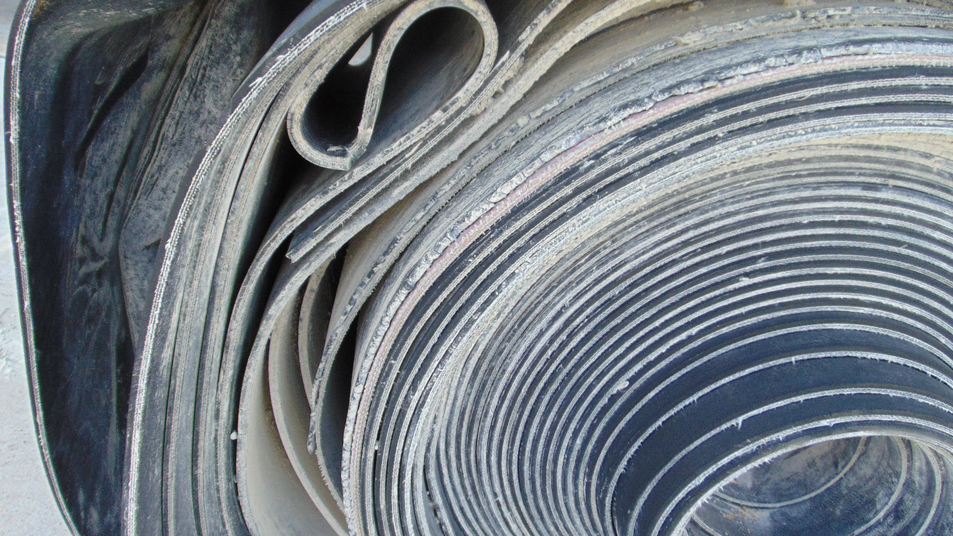 A roll of used rubber conveyor
