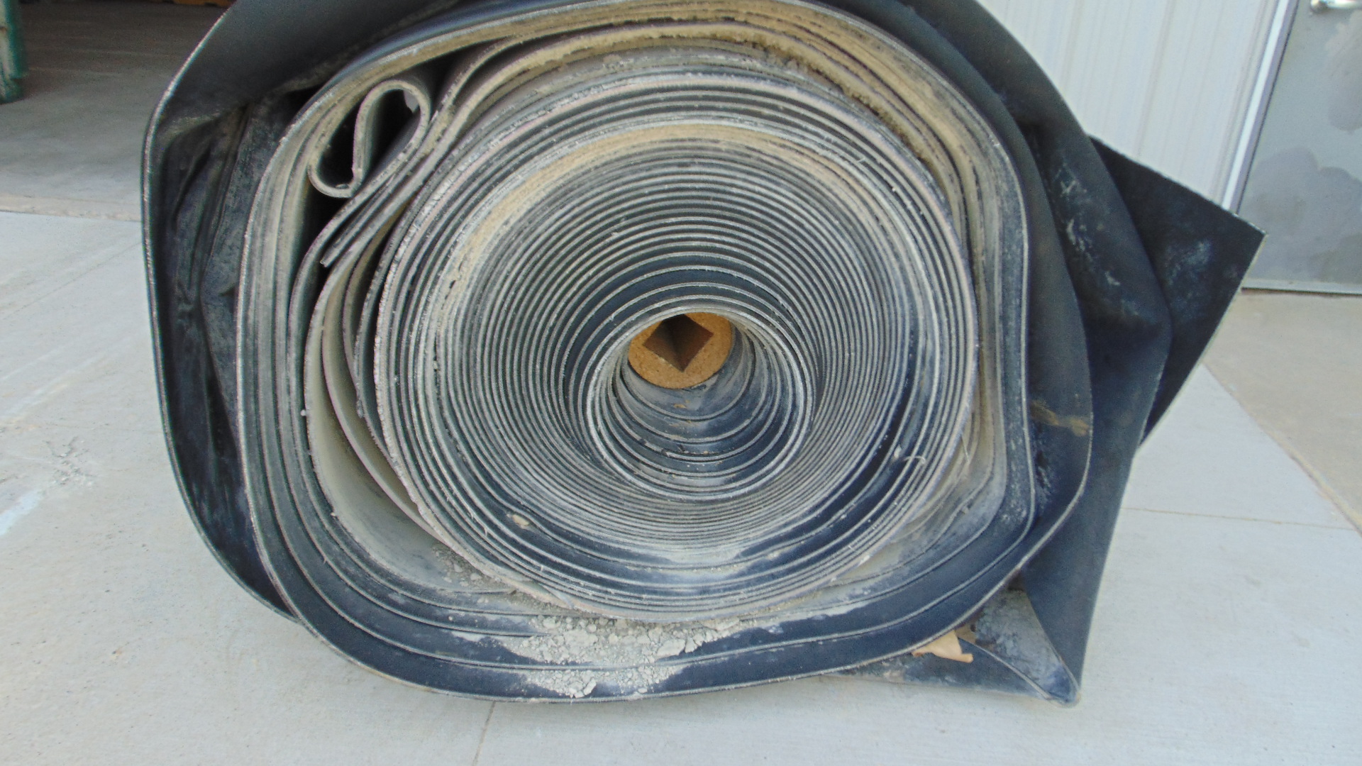 A roll of used rubber conveyor