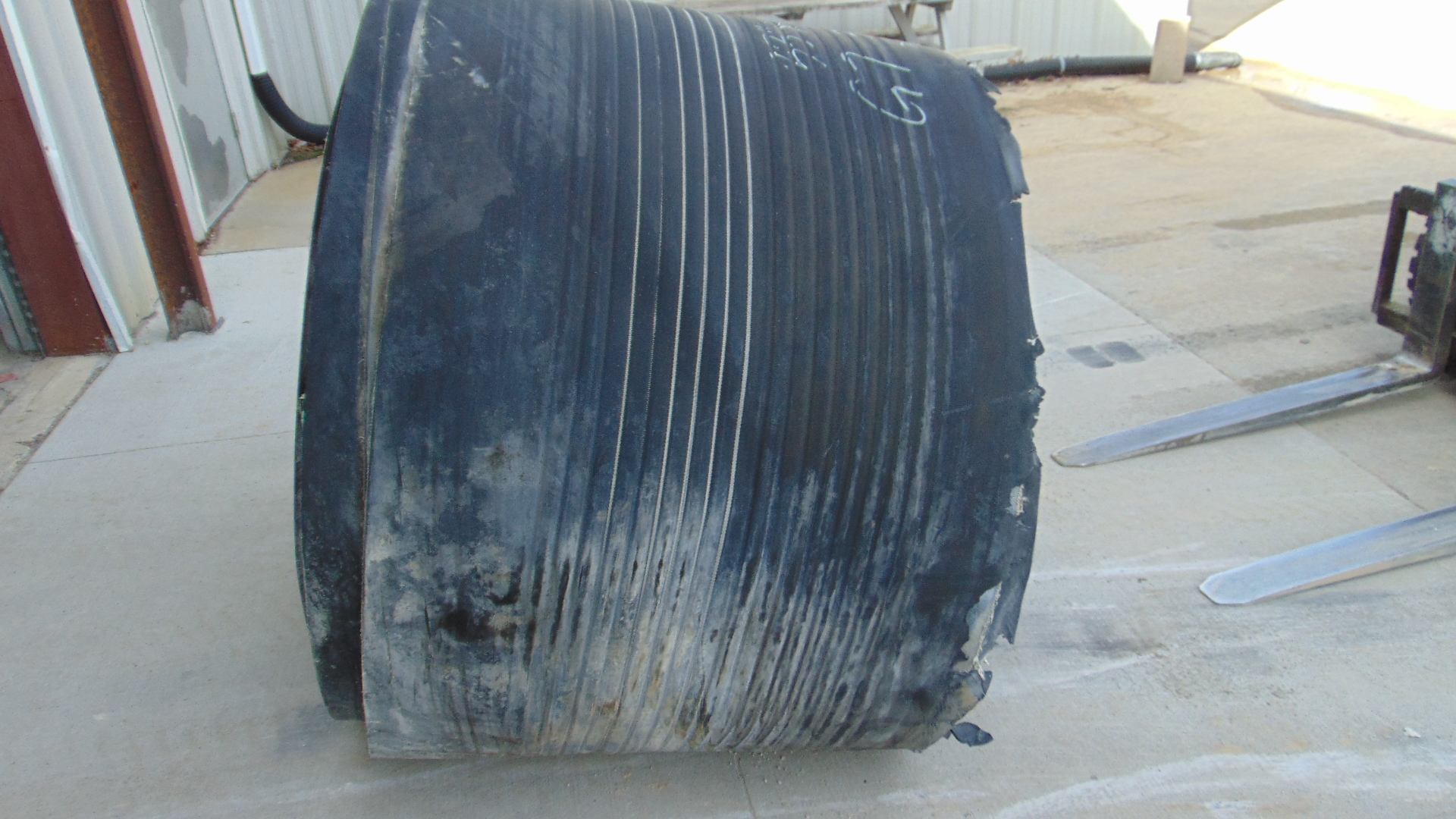 A roll of used rubber conveyor