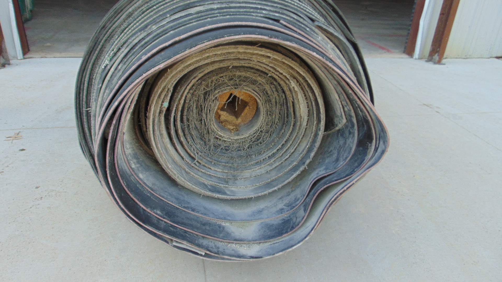 A roll of used rubber conveyor
