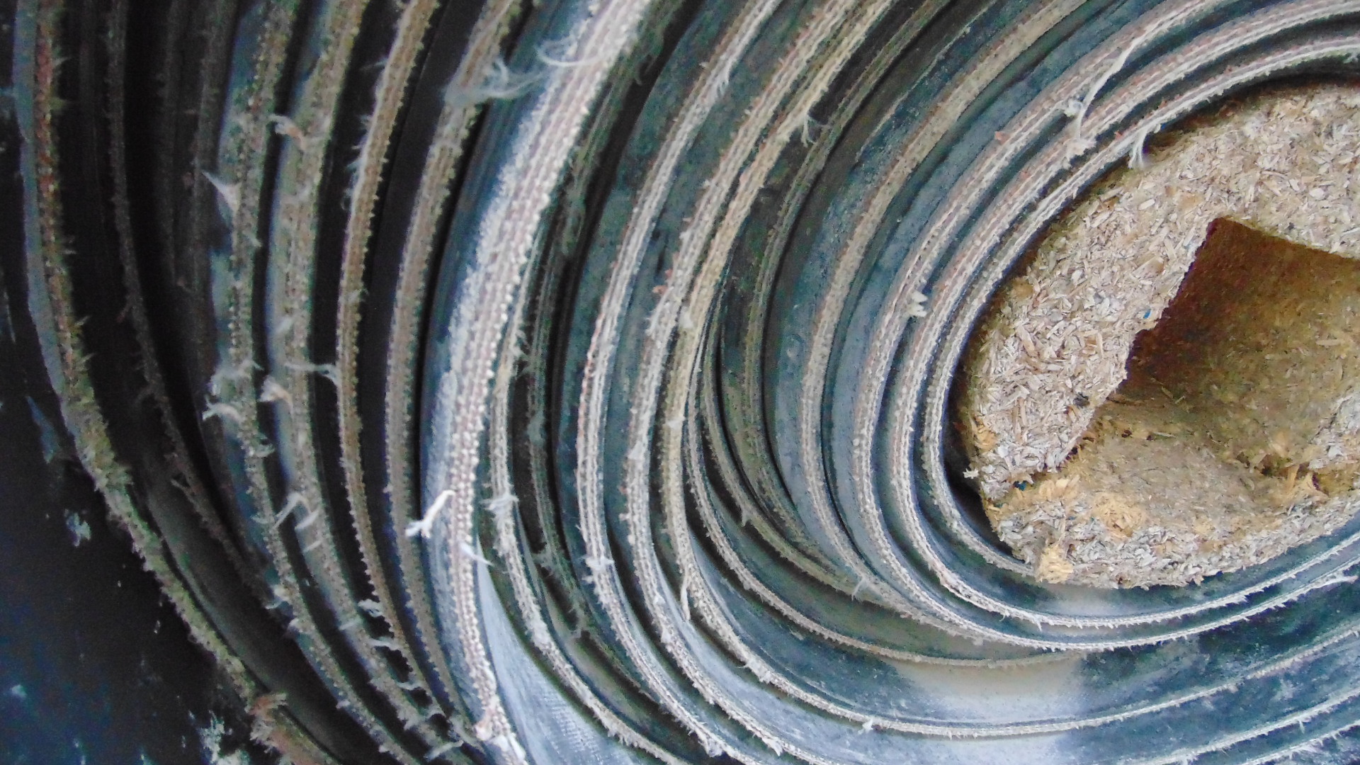 A roll of used rubber conveyor