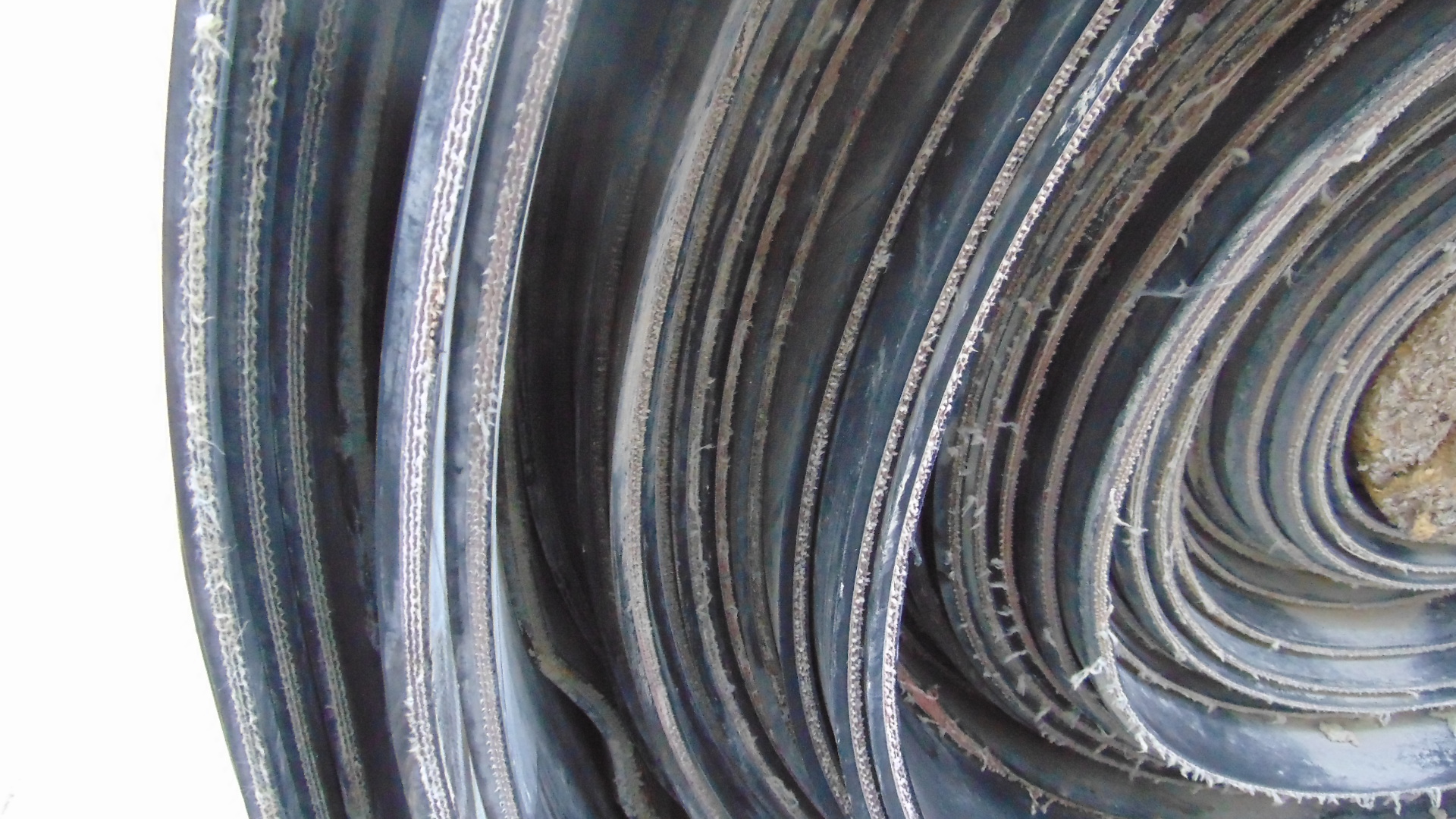 A roll of used rubber conveyor