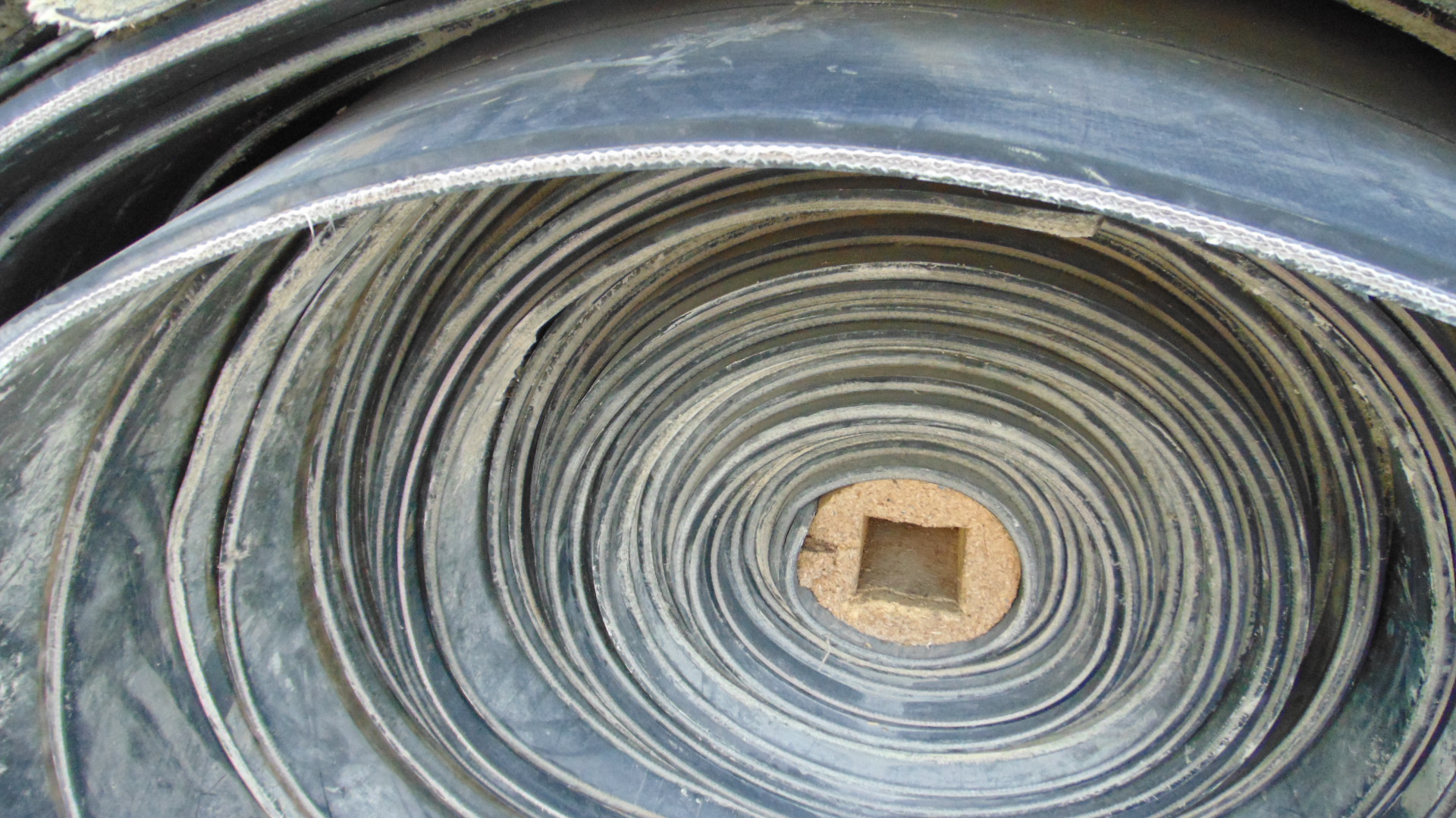 A roll of used rubber conveyor