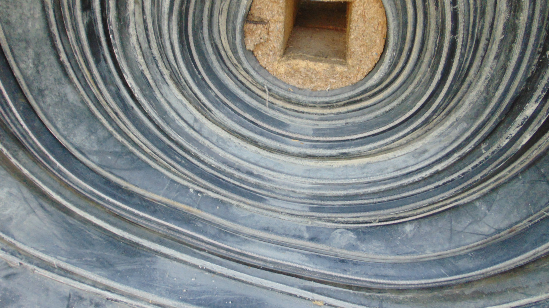 A roll of used rubber conveyor