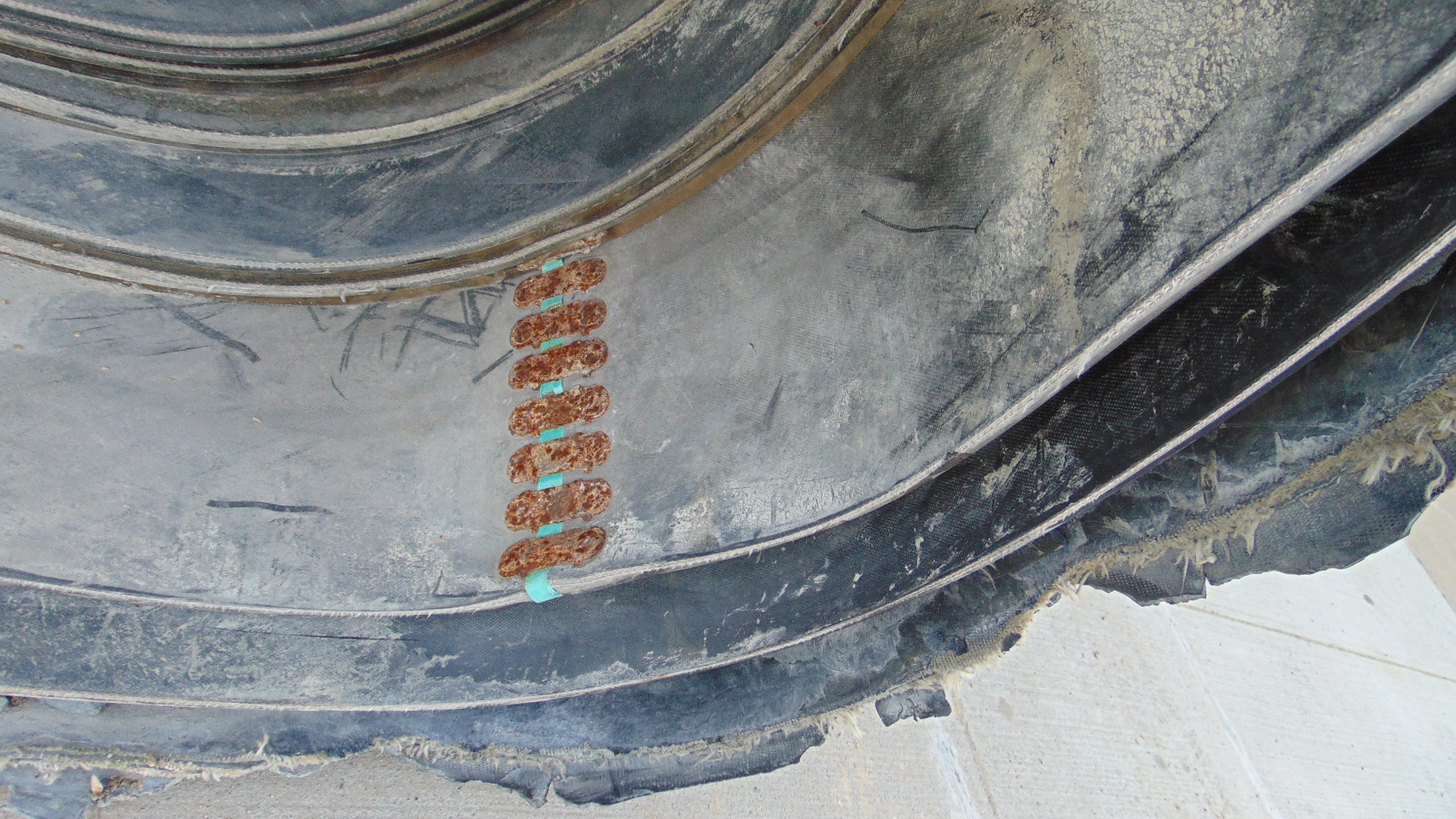 A roll of used rubber conveyor
