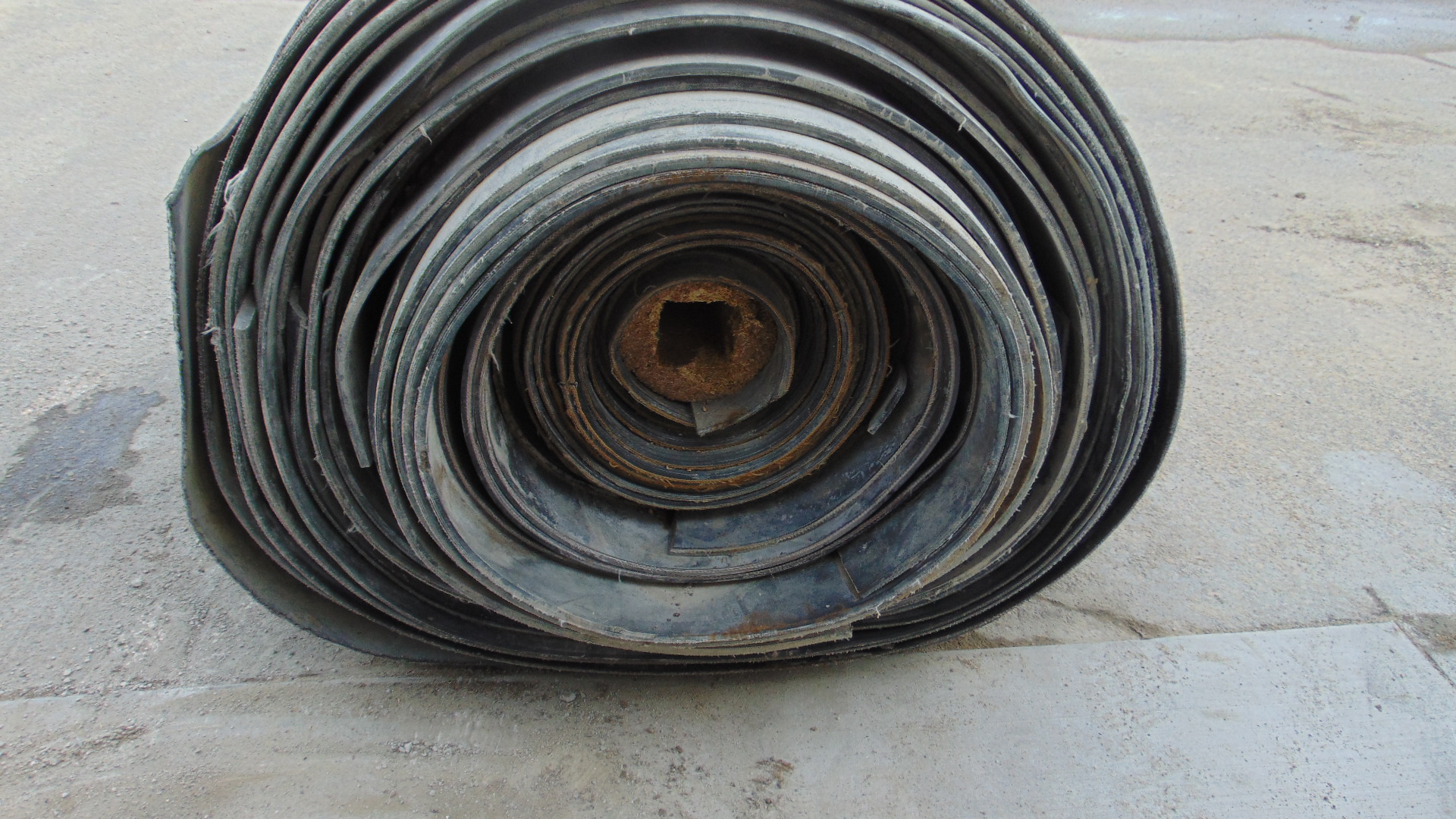 A roll of used rubber conveyor
