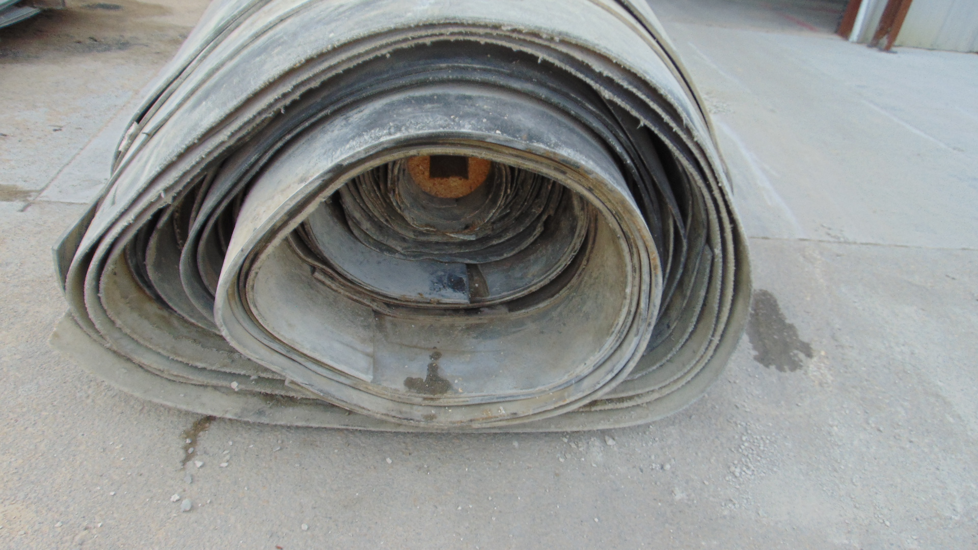 A roll of used rubber conveyor