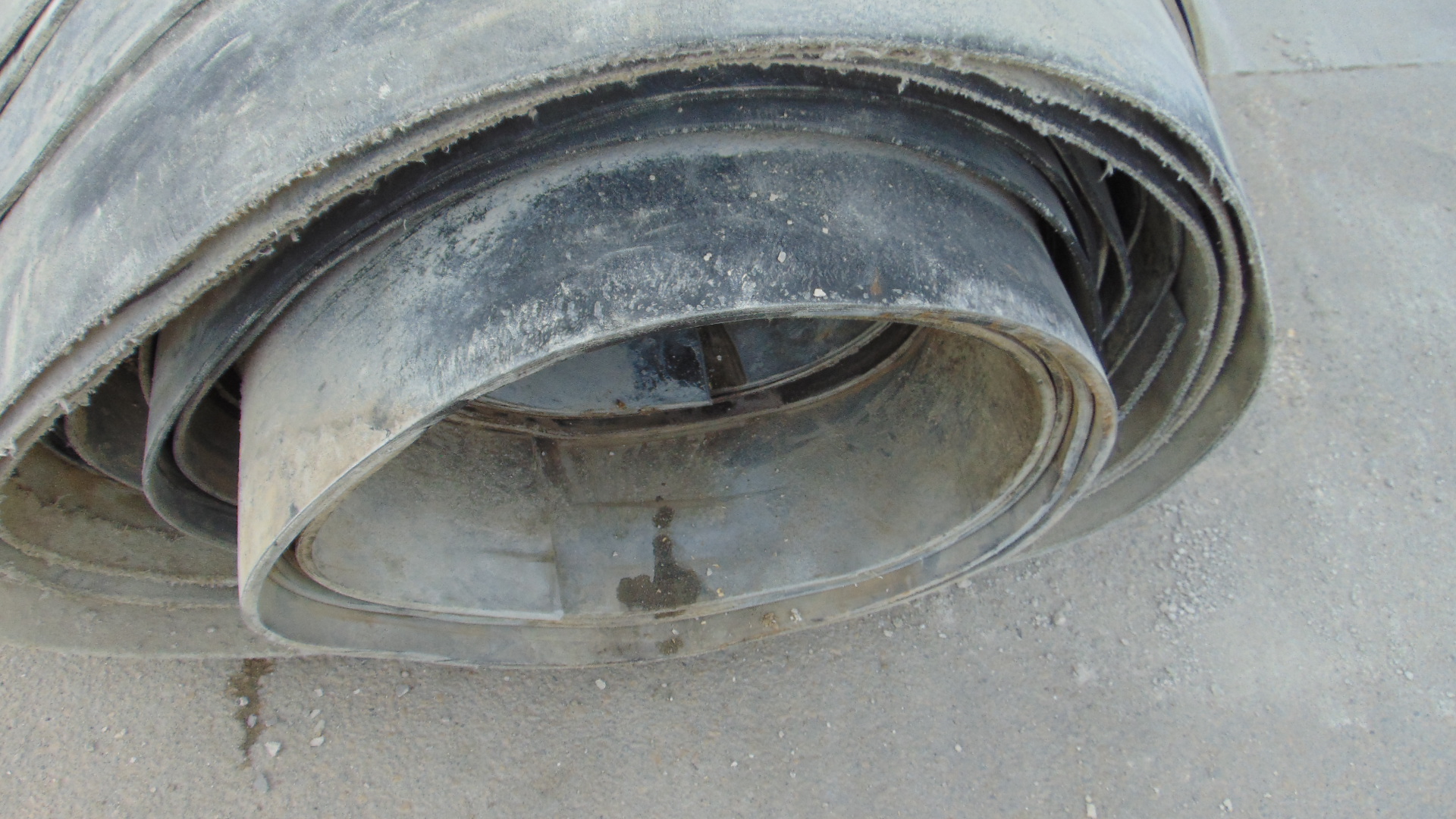 A roll of used rubber conveyor